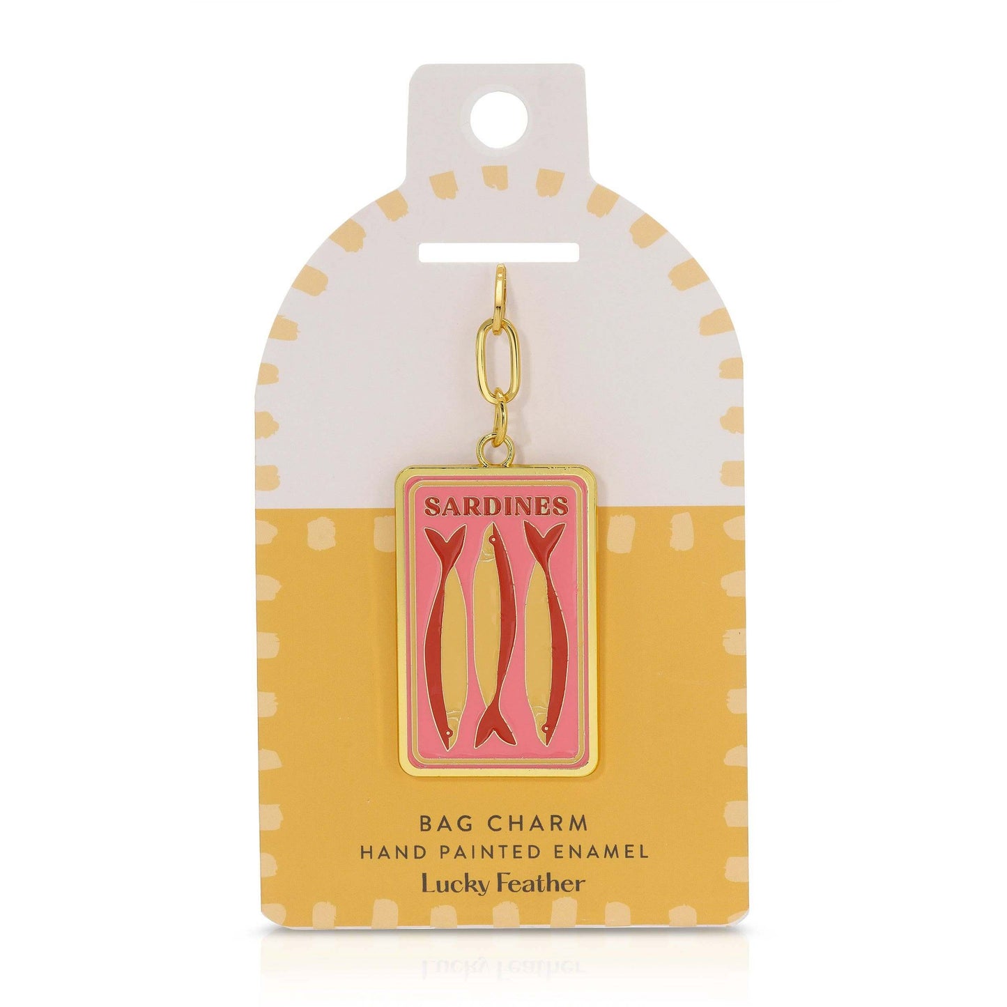 Sardine bag charm on a polka dot card with 'Lucky Feather' branding.