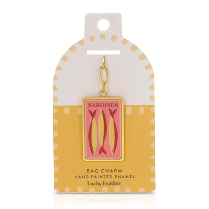 Sardine bag charm on a polka dot card with 'Lucky Feather' branding.