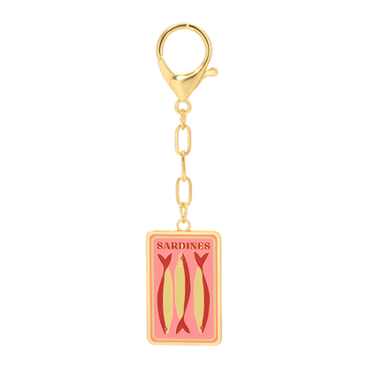 Gold charm with pink label featuring images of sardines on a white background