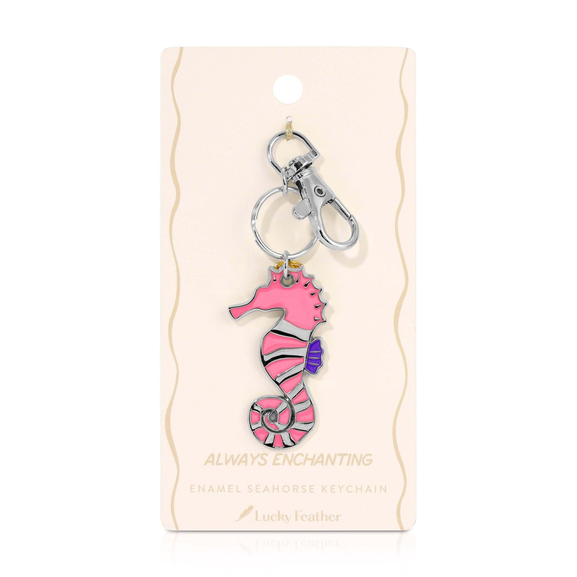 Pink seahorse keychain on a beige card with 'Always Enchanting' text