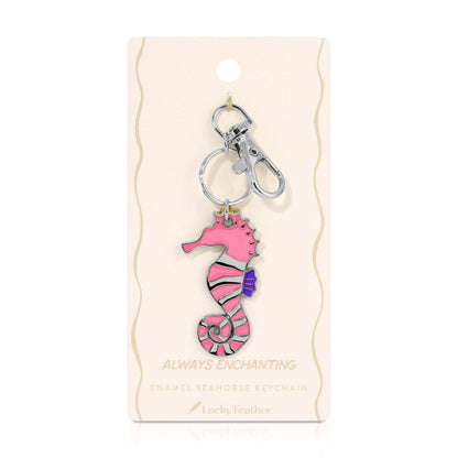 Pink seahorse keychain on a beige card with 'Always Enchanting' text