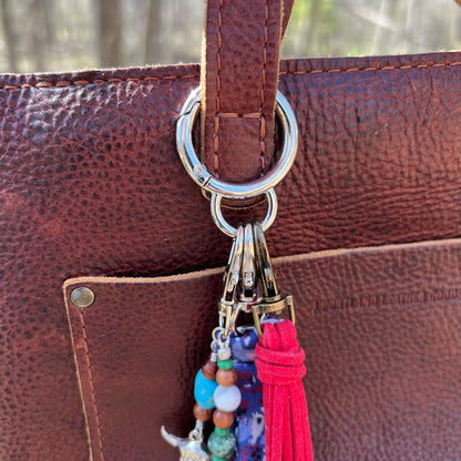spring gate bag charm holder on brown purse strap