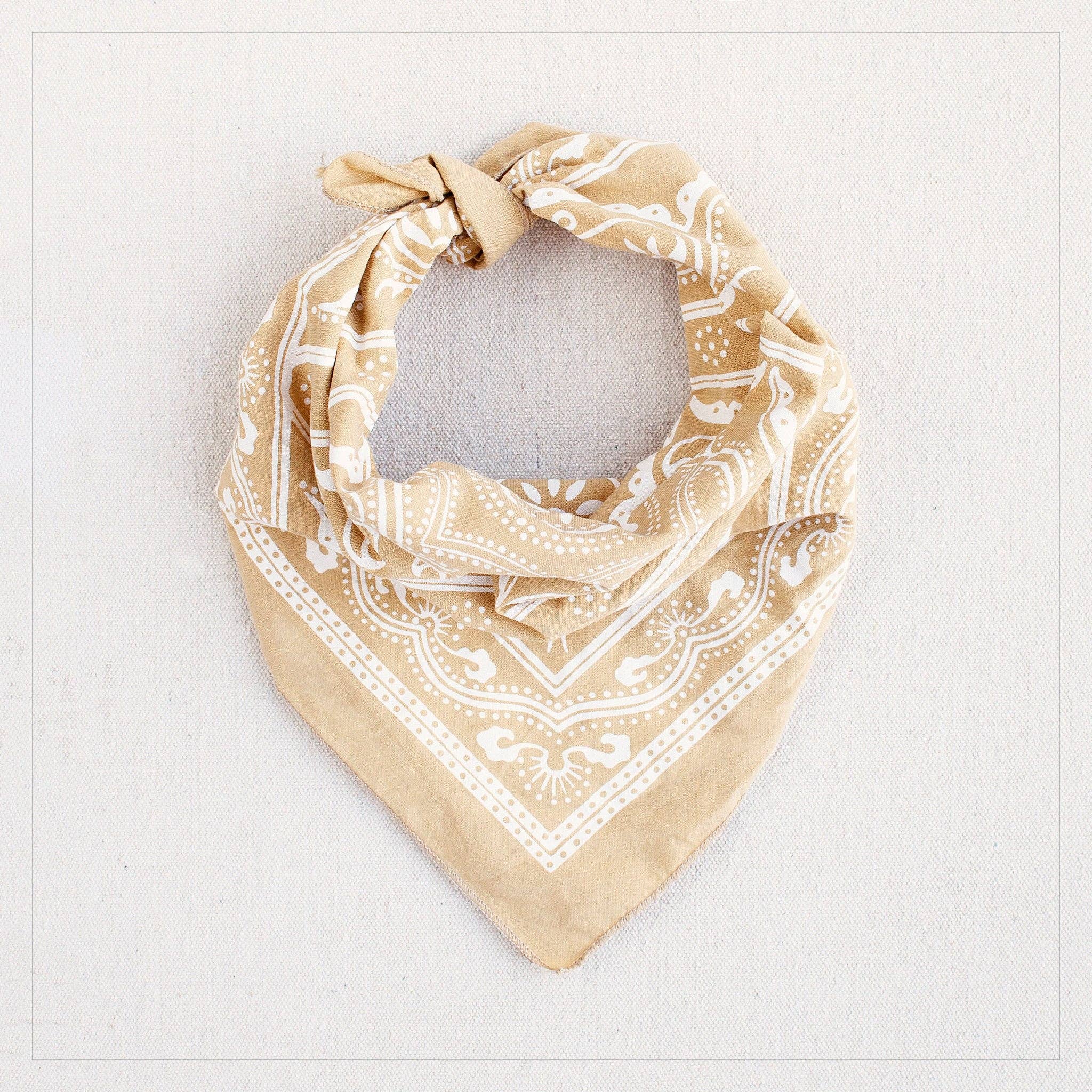 Beige bandana with white pattern on a light gray background