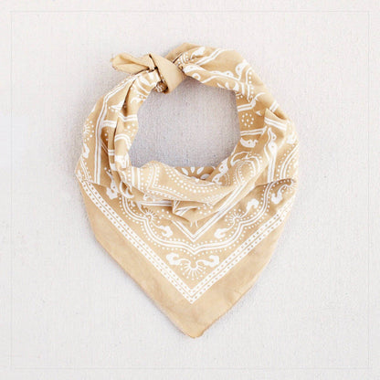 Beige bandana with white pattern on a light gray background