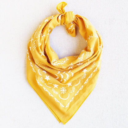 Yellow bandana with white patterns on a light gray background