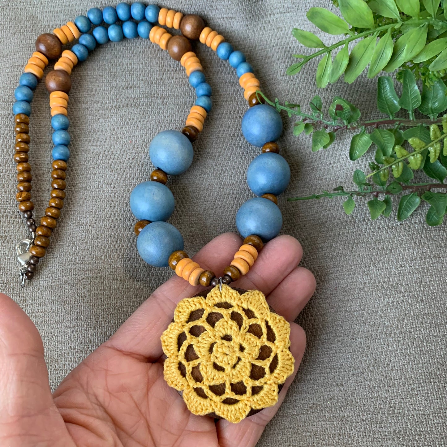 long boho style beaded necklace with crocheted pendant