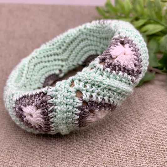 crocheted bangle bracelet in mint green, grey and white triangles