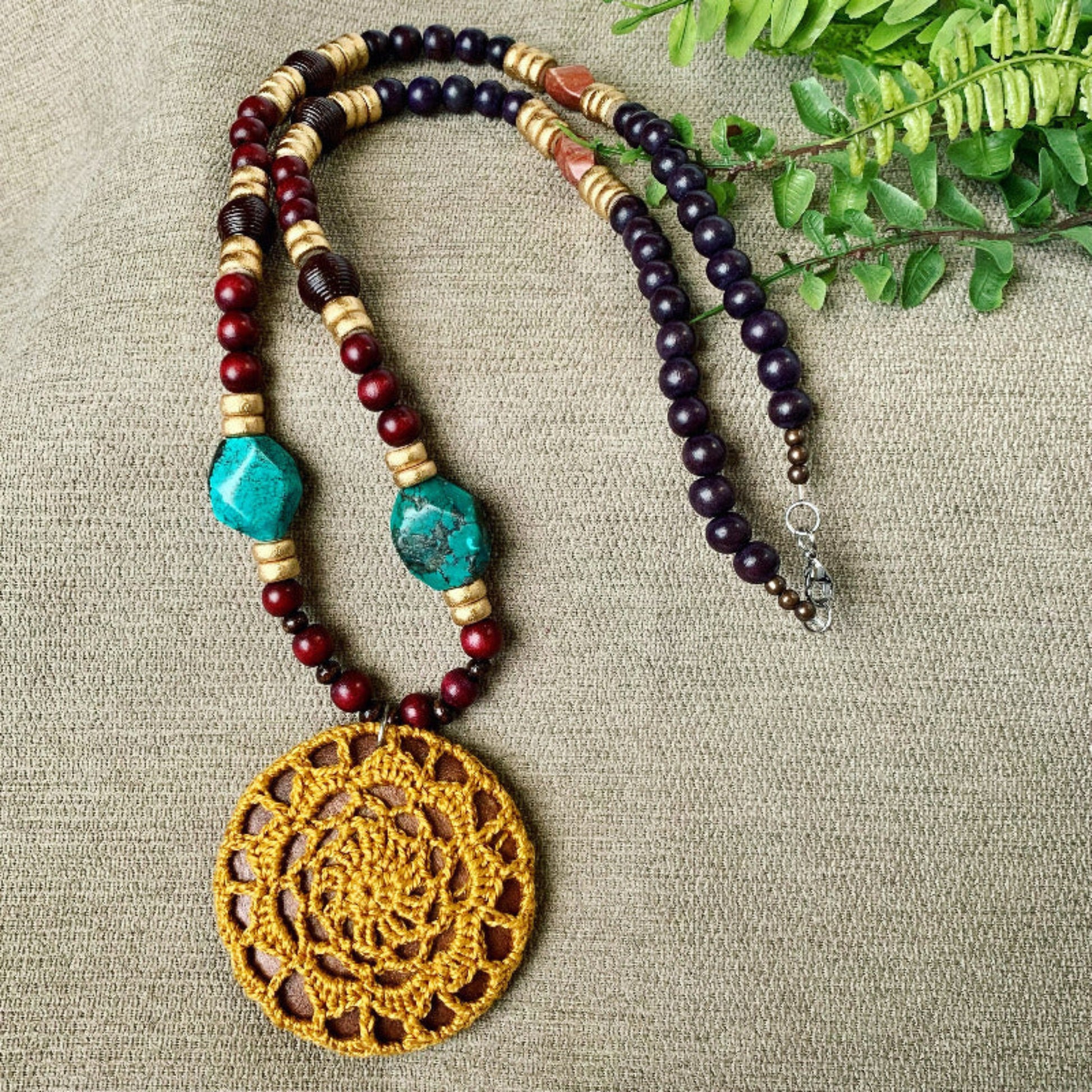 long beaded necklace with turquoise and crochet pendant